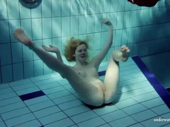 TubeHardcore presents: Blonde goes for a swim and strips